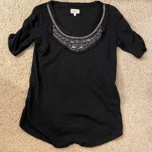 Black top with stunning beaded detail around neckline